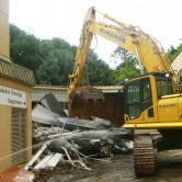 McMahon Services Excavator demolishing building at Lot Fourteen Demolition Site of the Old Royal Adelaide Hospital