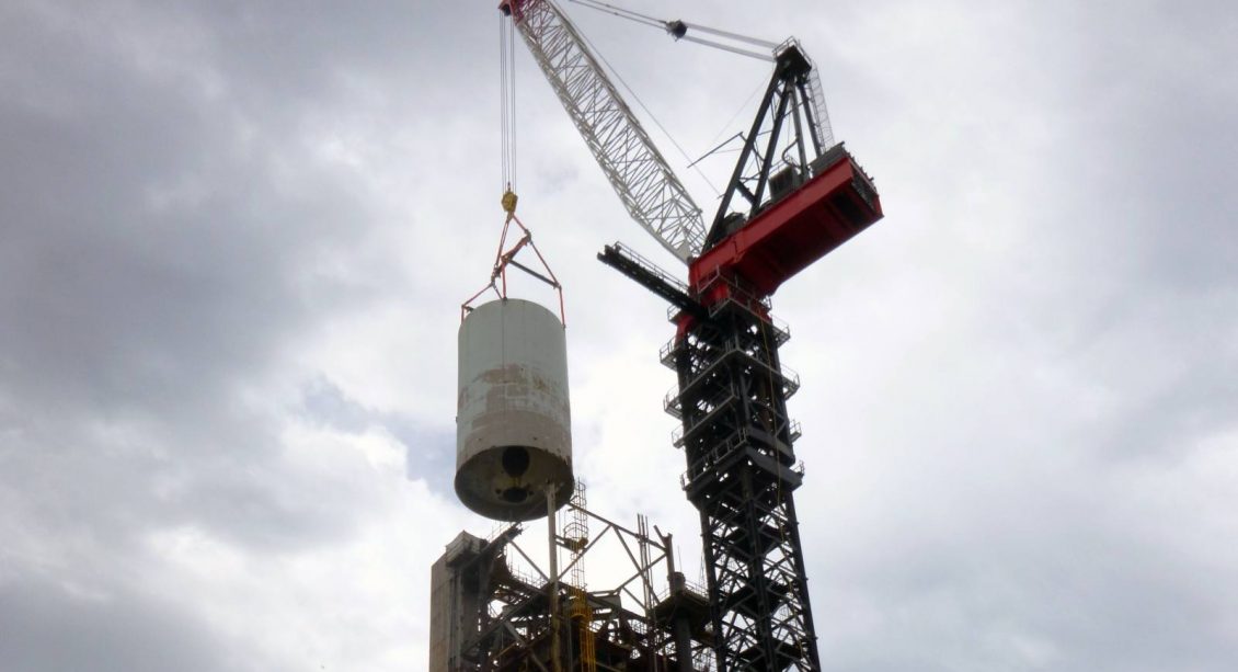 Crane lifting tower during Thermofor Catalytic Cracker Feed deconstruction project