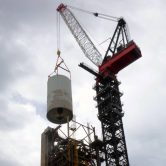 Crane lifting tower during Thermofor Catalytic Cracker Feed deconstruction project